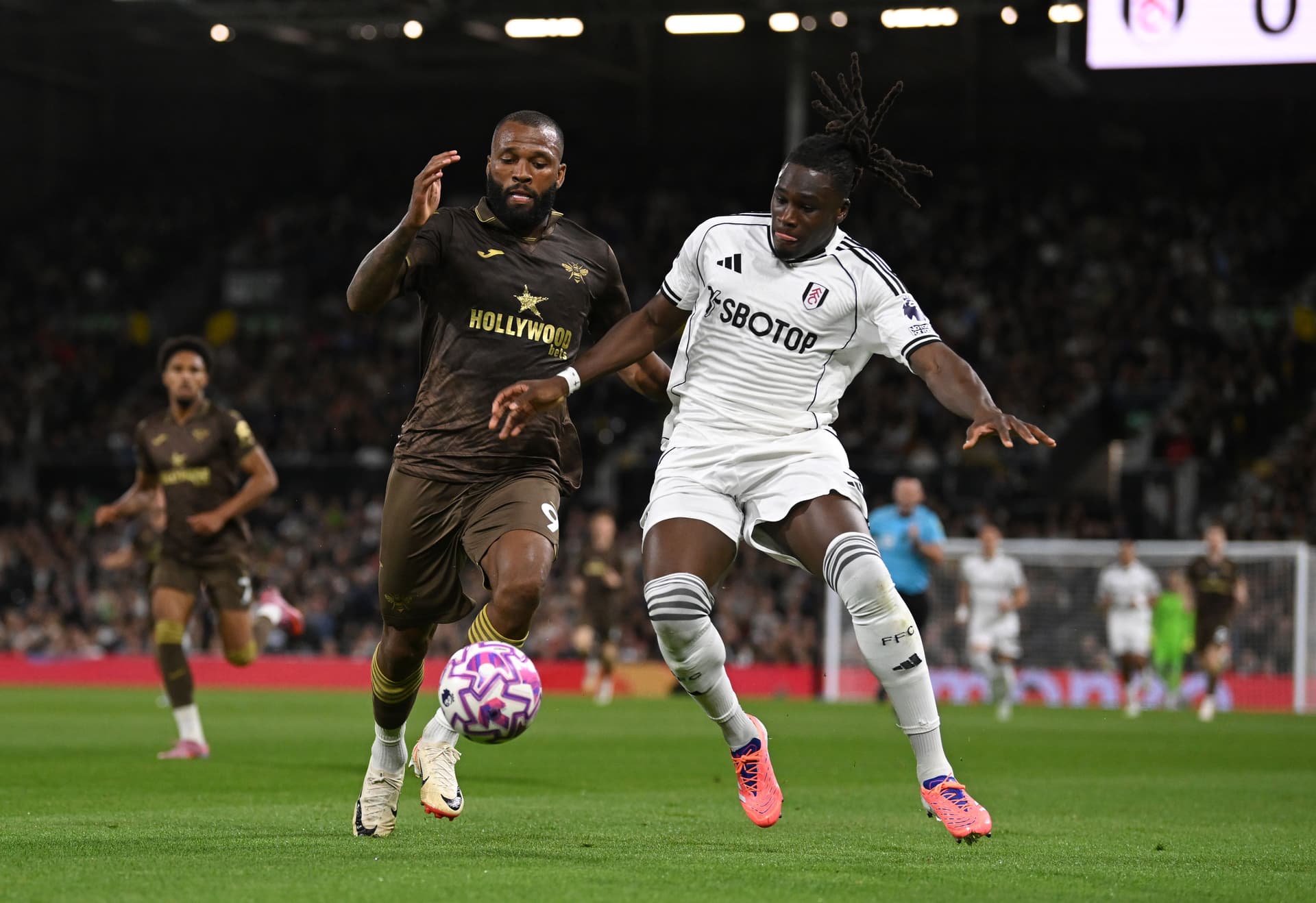Calvin Bassey of Fulham and Igor Thiago of Brentford battle for the ball during the Premier League