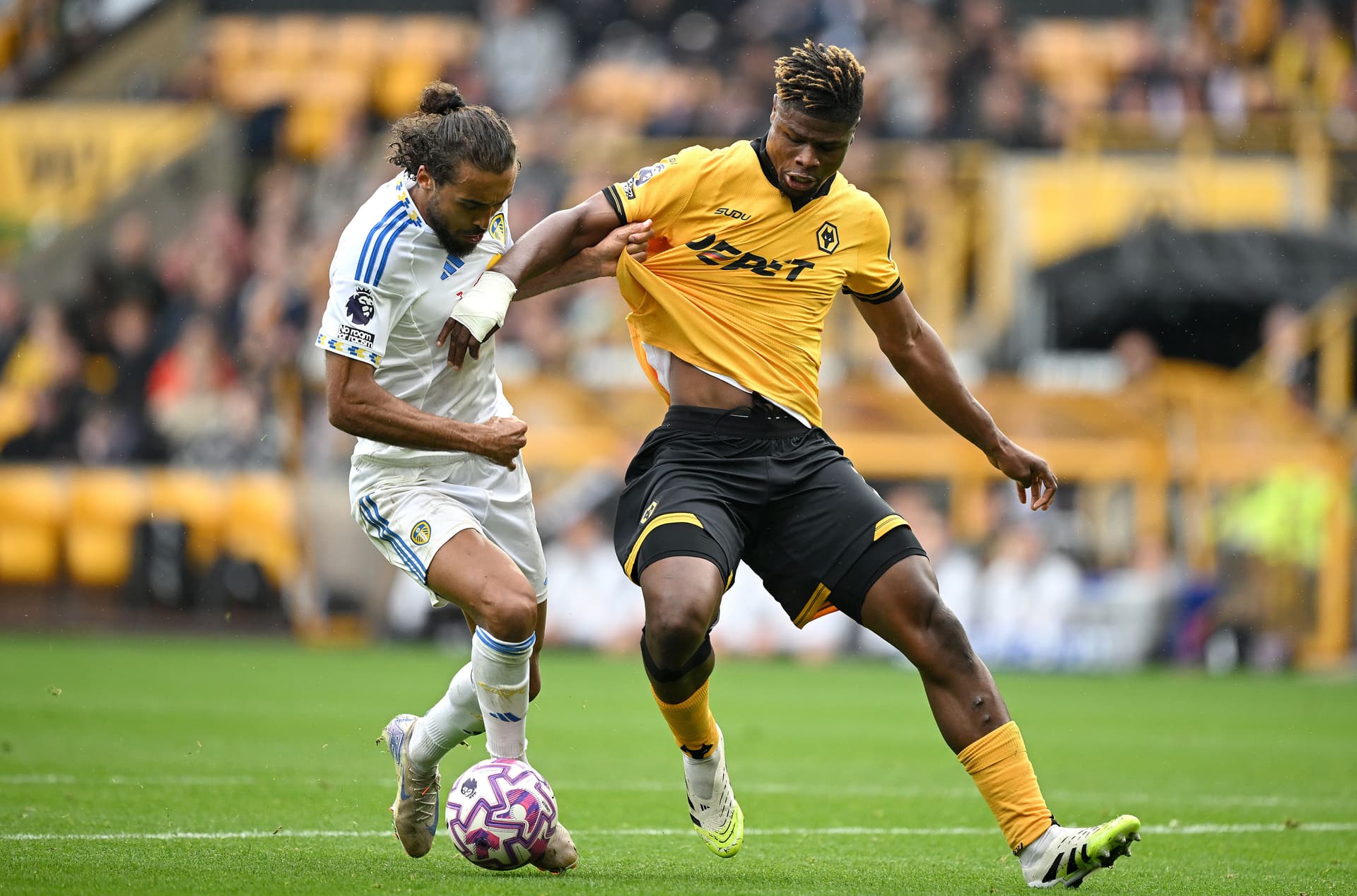Dominic Calvert-Lewin of Leeds United battles for possession with Emmanuel Agbadou of Wolverhampton Wanderers