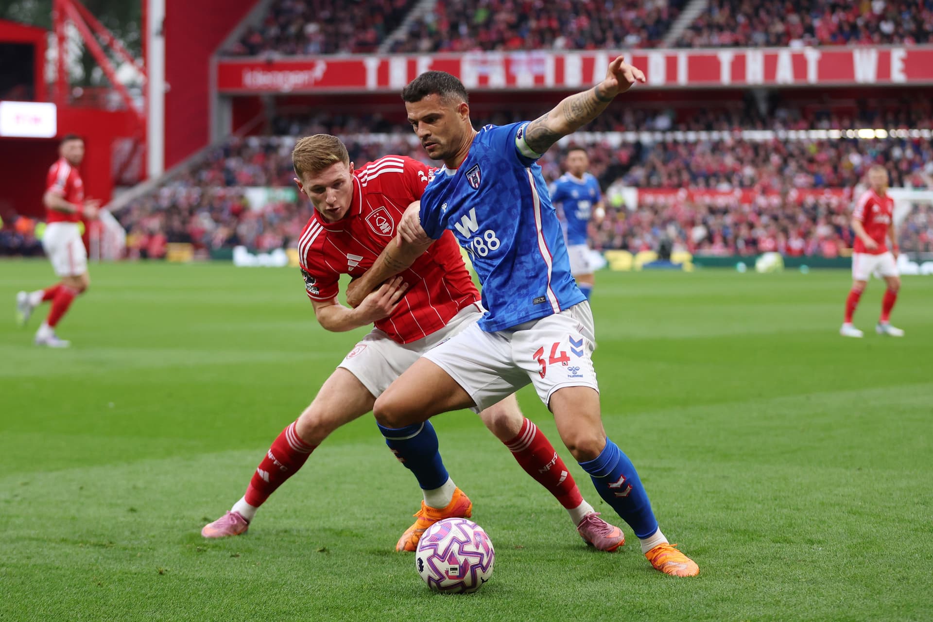 Granit Xhaka of Sunderland holds off Elliot Anderson of Nottingham Forest during the Premier League