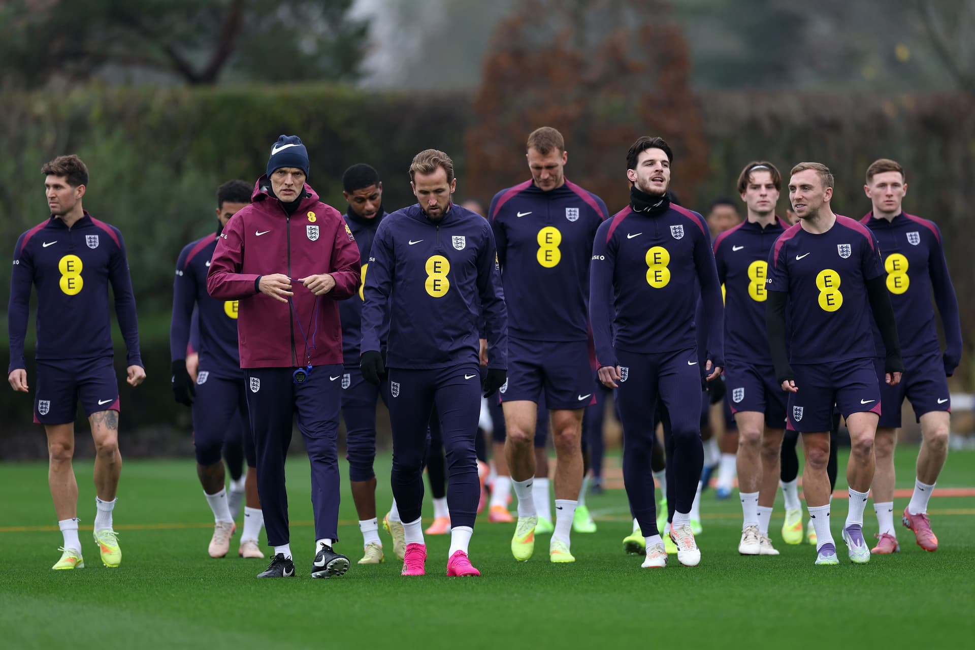 Thomas Tuchel, Head Coach of England, and players of England walk during a training session